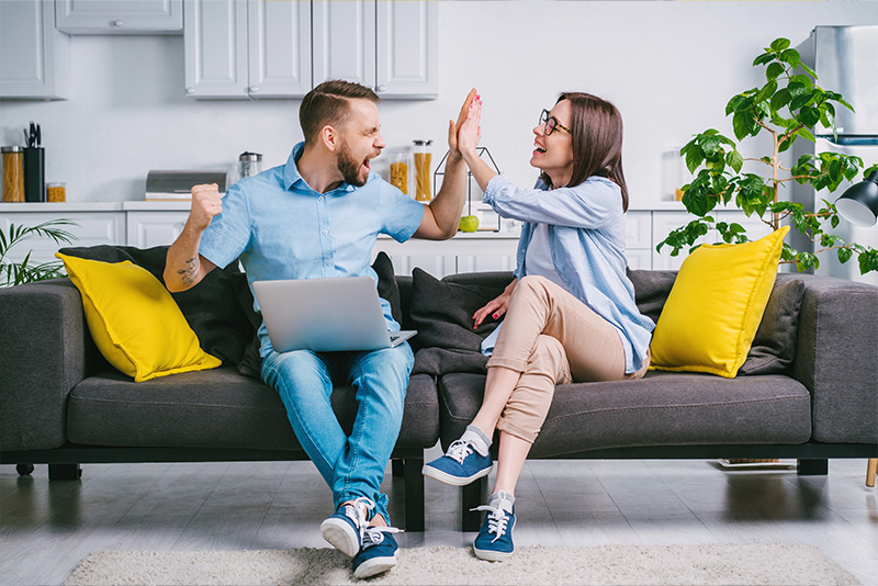 an excited couple on a couch